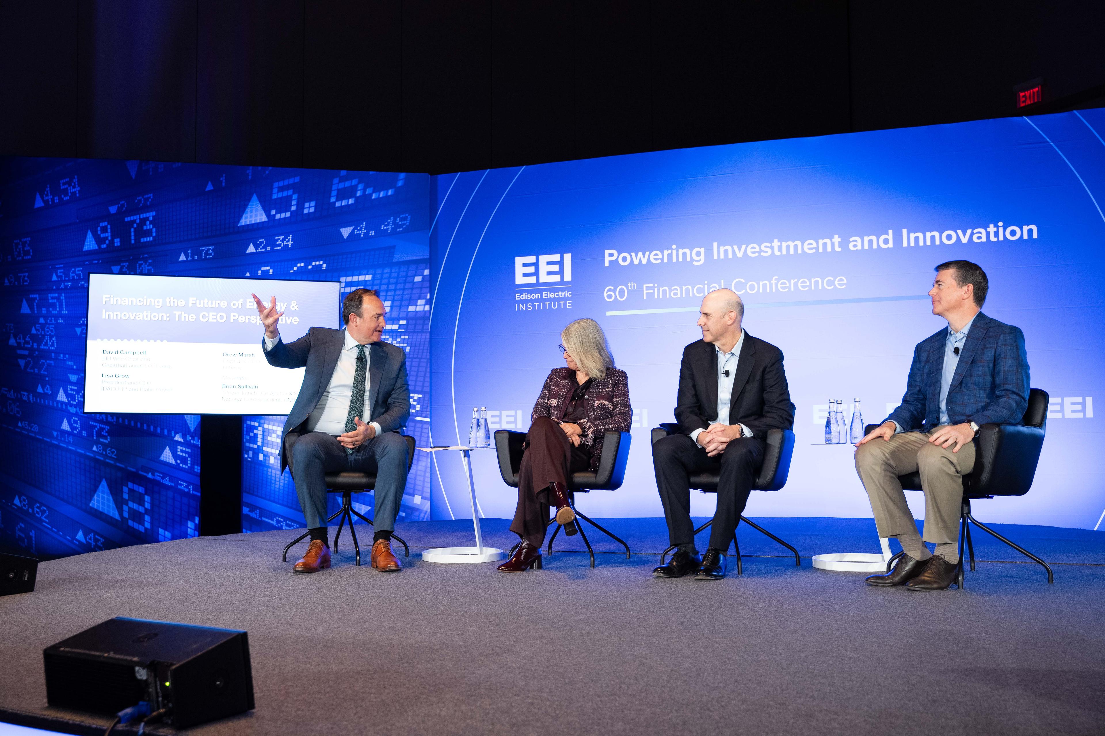 People speaking on stage with EEI logo in the back.
